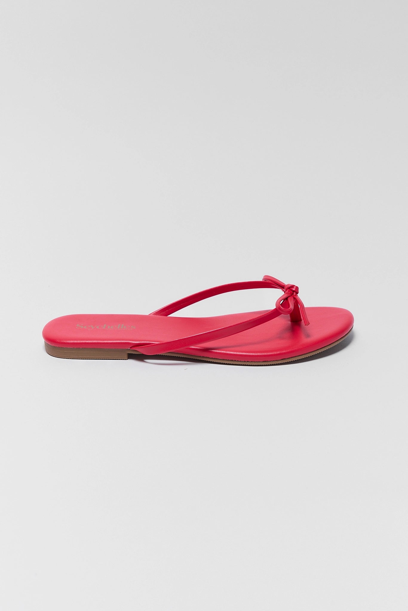 one Red sandal on a light gray background
