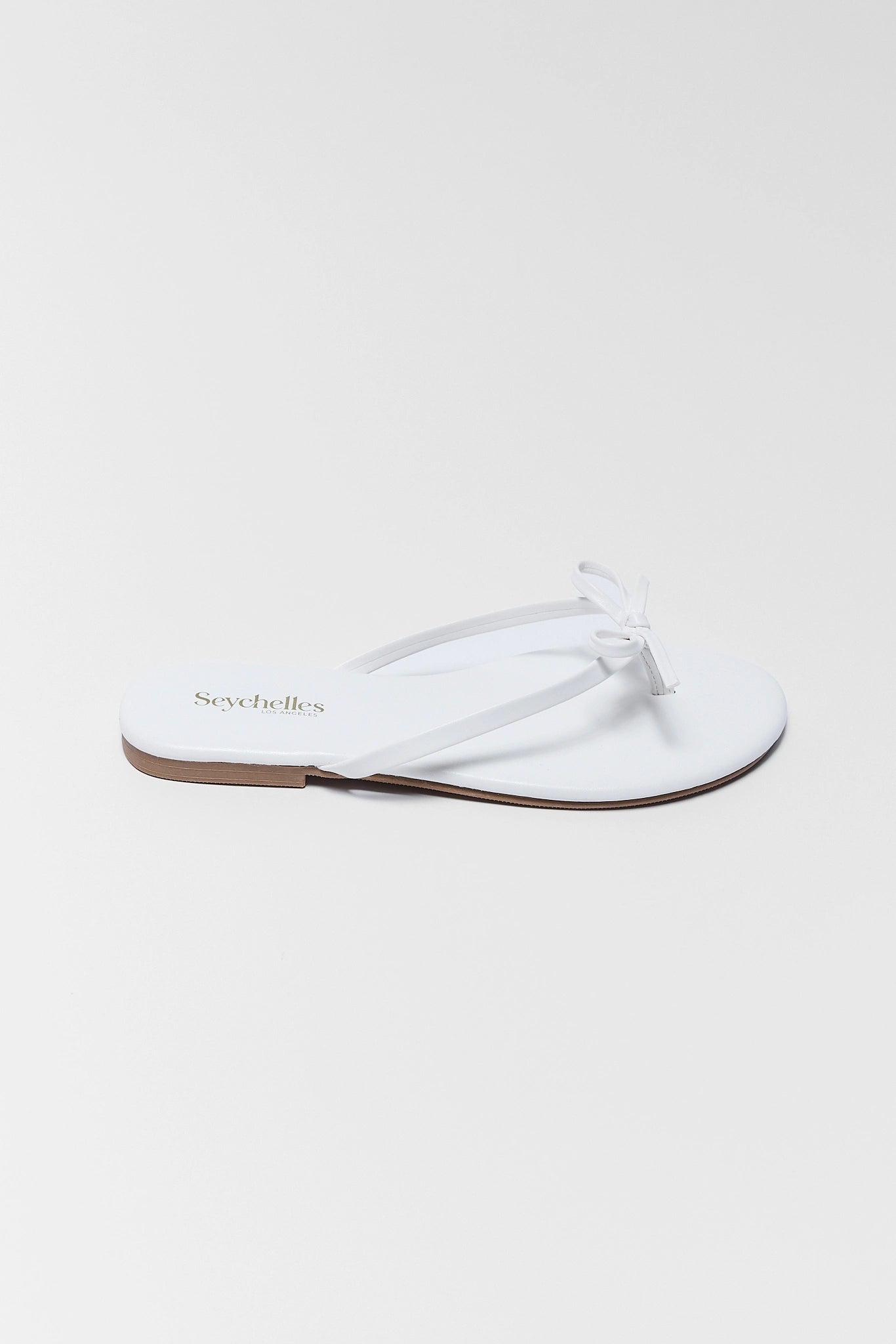 one White sandal with text on a white background