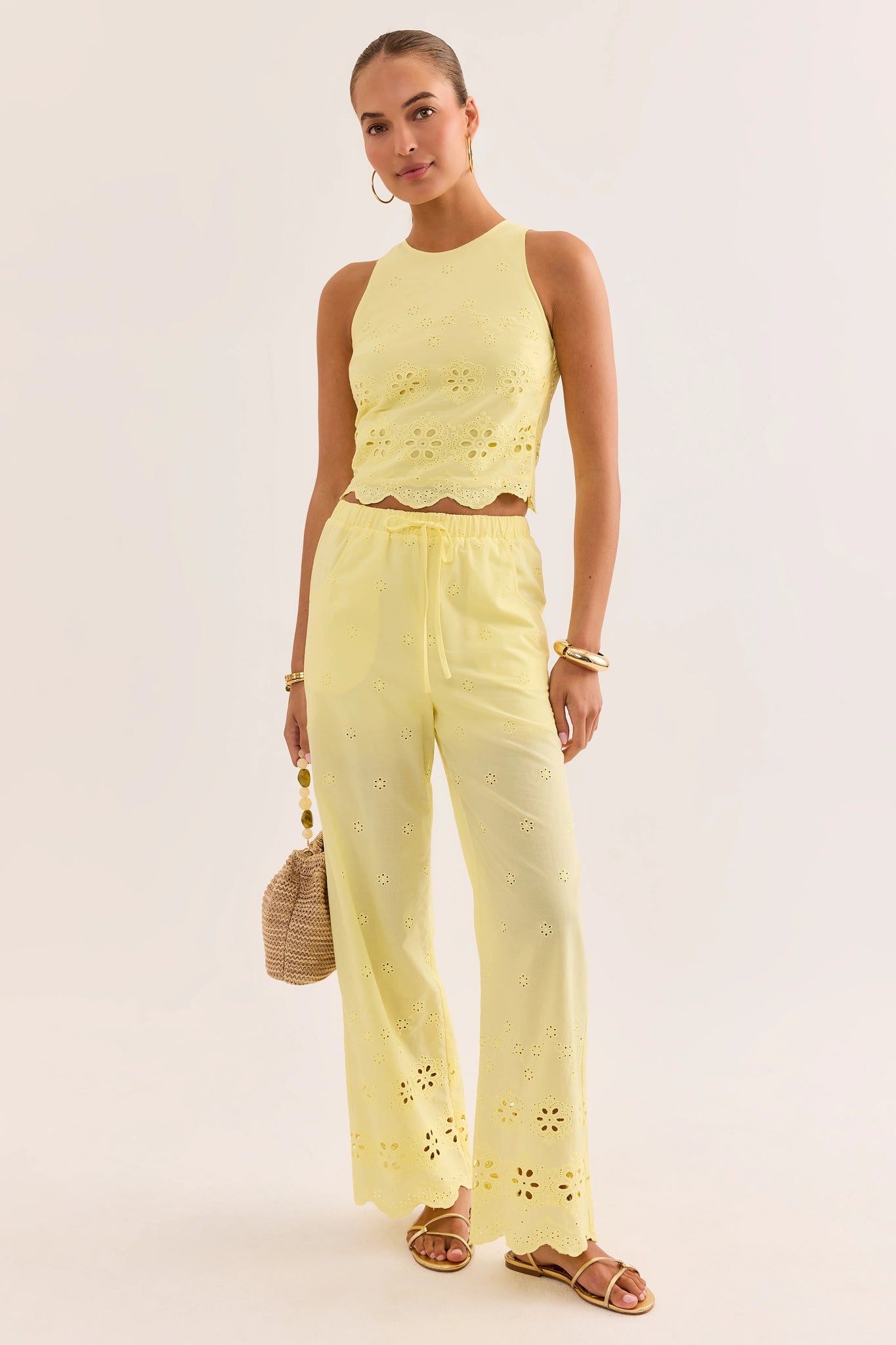 Woman wearing a yellow outfit with floral patterns on a white background lifestyle