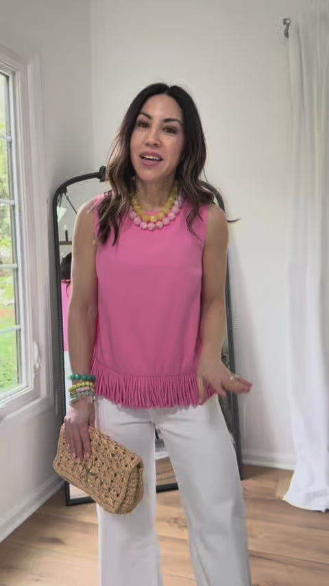 woman wearing pink fringe angelina top with mirror in background