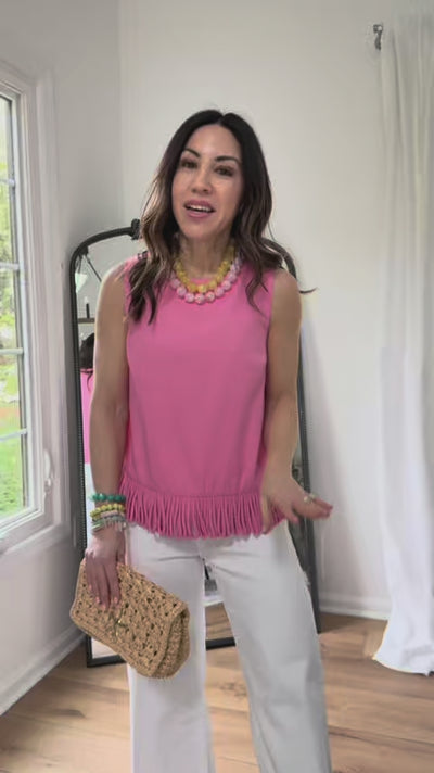 woman wearing pink fringe angelina top with mirror in background