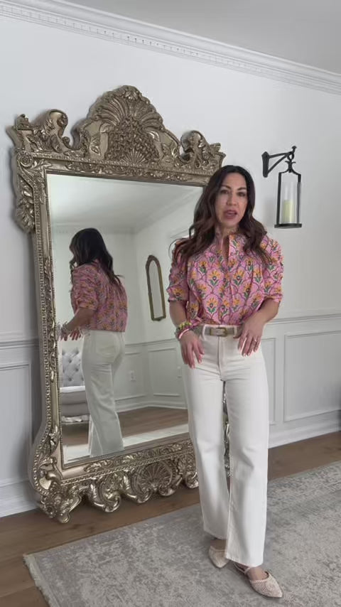 Woman standing in front of mirror wearing Maya pink multi floral top with white jeans