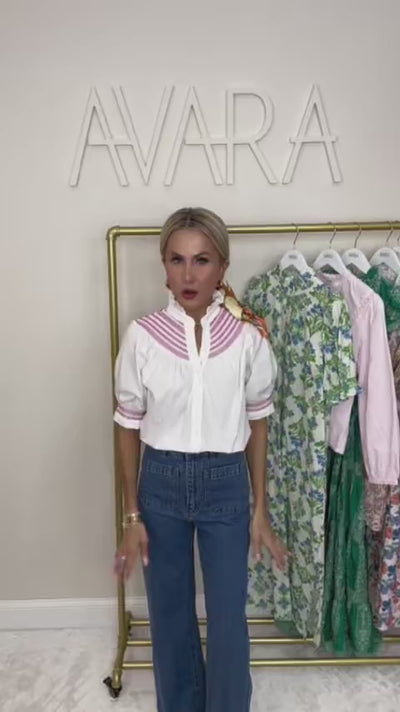 woman wearing white top with rack in background
