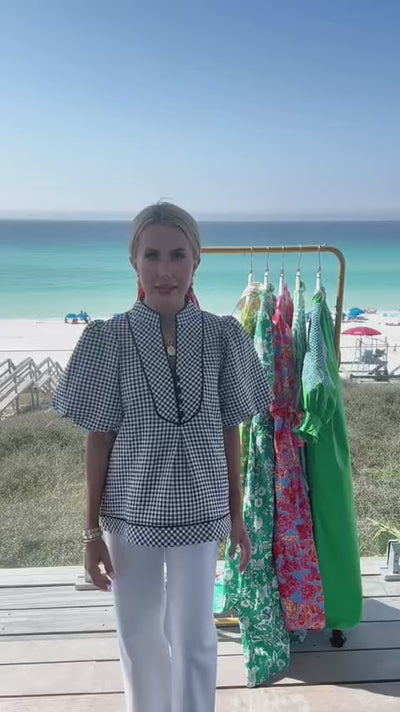 woman wearing valerie navy top with beach in background