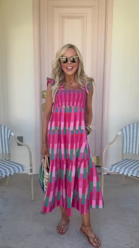 woman in avery midi dress wearing sunglasses standing outside
