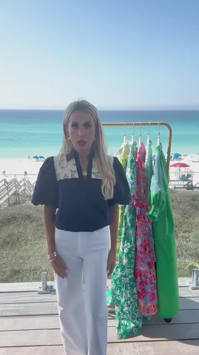 woman wearing penelope navy top with beach in background