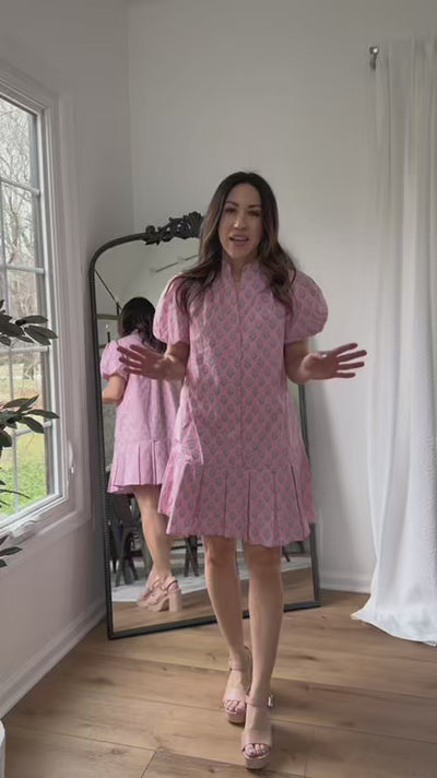 Woman wearing Holly Pink Floral Dress with a mirror in background