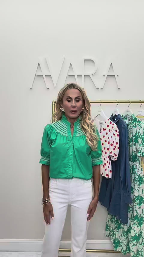 woman wearing green top with rack in background