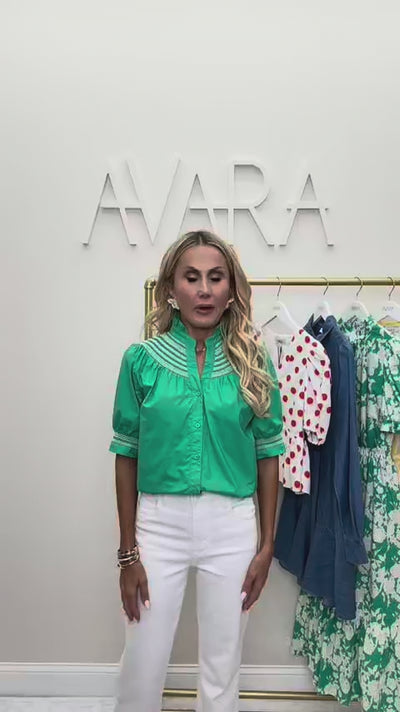 woman wearing green top with rack in background