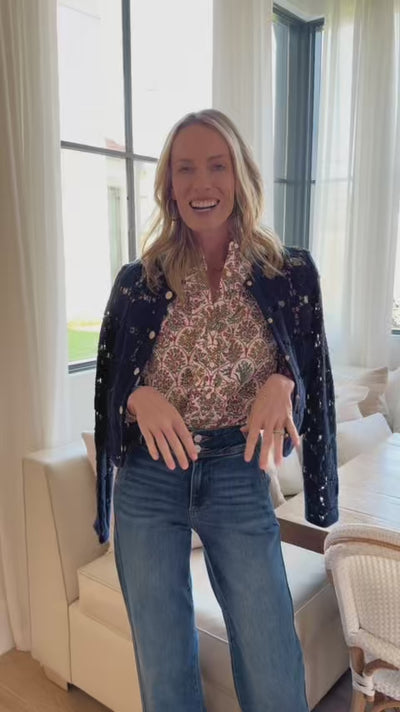 Woman wearing Anita floral top with windows in background