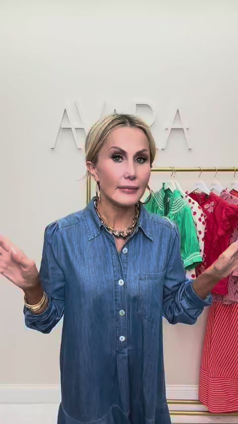 woman wearing meagan chambray dress with rack in background