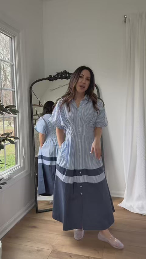 Woman wearing Diana Blue Maxi Dress with a mirror in background