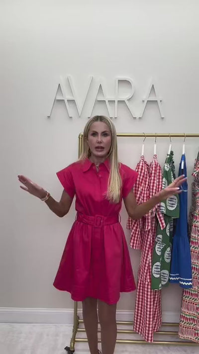 Woman wearing red riley dress with AVARA letters in background