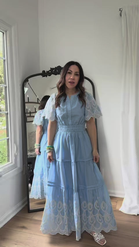 woman wearing blue brylee dress with mirror in background