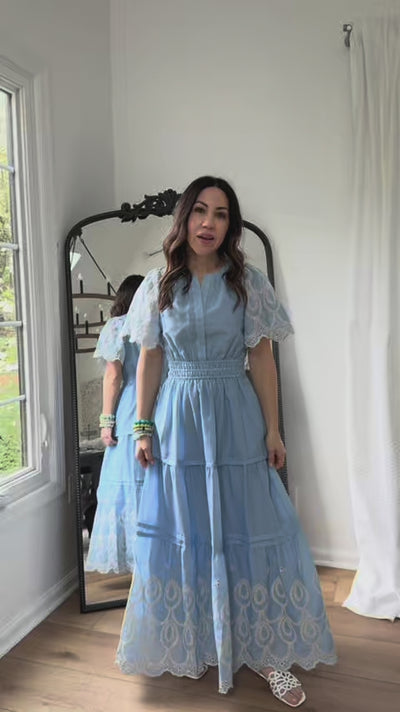 woman wearing blue brylee dress with mirror in background