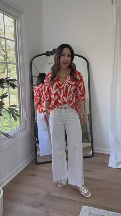 woman wearing trish top orange by mirror