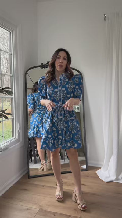 woman wearing lily short dress with mirror in background