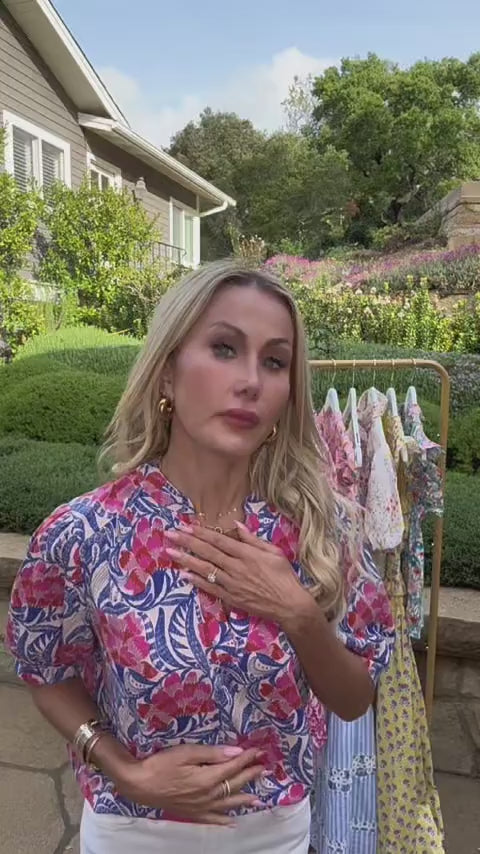 Woman in blue printed puff sleeve top outside 