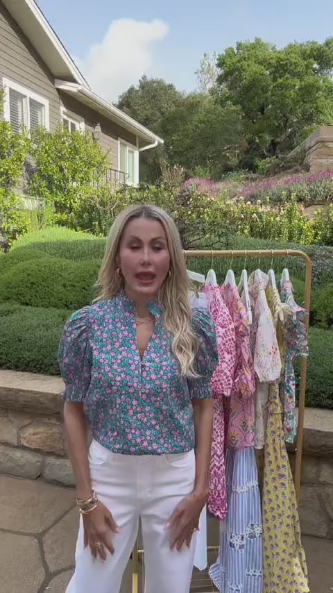 Woman wearing blue floral puff sleeve top outside 
